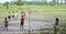 Burmese young men are playing football on rice filed in Inwa, Myanmar (Burma).