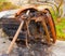 A burned car propped on its side in the caribbean