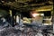 Burned interiors after fire in industrial or office building. Walls and staircase in black soot