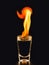 Burning alcoholic drinks with big flame, on black background with copy space