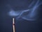 Burning aromatic incense stick with cinder and smoke on a gray background with copy space