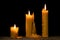 Burning beeswax candles in dark. Copy space for text.