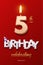 Burning Birthday candle in the form of number 5 figure and Happy Birthday celebrating text with party cane isolated on