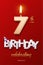 Burning Birthday candle in the form of number 7 figure and Happy Birthday celebrating text with party cane isolated on