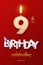 Burning Birthday candle in the form of number 9 figure and Happy Birthday celebrating text with party cane isolated on