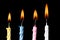 Burning birthday candles on black