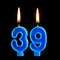 Burning birthday candles in the form of 39 thirty nine for cake isolated on black background.