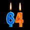 Burning birthday candles in the form of 64 sixty four for cake isolated on black background.