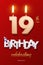 Burning Birthday candles in the form of number 19 figure and Happy Birthday celebrating text with party cane isolated on