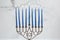 Burning blue candles on a Jewish menorah at Hanukkah