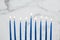 Burning blue candles on a Jewish menorah at Hanukkah