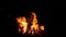 burning bonfire on a black background with bright erupting sparks. Natural background.