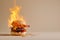 Burning burger, cheeseburger on fire. Hot hamburger in flames, spicy food, burning calories, weight loss and healthy diet concept