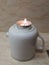 Burning candle in aluminium wrapper