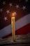 Burning candle and american flag.