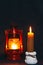 A burning candle on the background of a kerosene lamp. Festive arrival. Beautiful handmade candles. Cozy atmosphere in the house