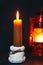 A burning candle on the background of a kerosene lamp. Festive arrival. Beautiful handmade candles. Cozy atmosphere in the house