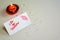 Burning candle and Be My Valentine white message card with lips imprint