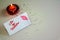 Burning candle and Be My Valentine white message card with lips imprint