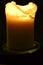 Burning candle on a black background - flame photography