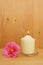 Burning candle and camellia flower