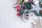 Burning candle and Christmas decoration over snow and wooden background, elegant low-key shot with festive mood