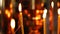Burning candle closeup on the background of other candles in the Christian Orthodox Church