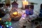 A burning candle in a glass holder in an atmospheric cozy atmosphere at home at night by the light of a garland. Holiday