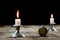 Burning candle and old watch on a wooden table. Flowing time and
