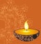 Burning candle on an orange background