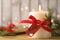 Burning candle with pinecone scent on wooden table, closeup. Space for text