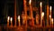 Burning candles on background of the Golden crucifixion of Jesus Christ