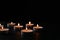Burning candles on black background, space for text. Holocaust memory day