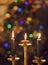 Burning candles on blurring Christmas lights background