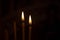 Burning candles in church. Burning candles shining in dark background. Copy space.