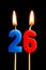 Burning candles in the form of 26 twenty six numbers, dates for cake isolated on black background. The concept of celebrating a