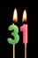 Burning candles in the form of 31 thirty one numbers, dates for cake isolated on black background. The concept of celebrating a