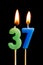 Burning candles in the form of 36 thirty six numbers, dates for cake isolated on black background. The concept of celebrating a