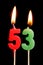 Burning candles in the form of 53 fifty three numbers, dates for cake isolated on black background. The concept of celebrating a