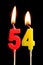 Burning candles in the form of 54 fifty four numbers, dates for cake isolated on black background. The concept of celebrating a