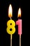 Burning candles in the form of 81 eighty one numbers, dates for cake isolated on black background. The concept of celebrating a