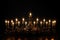 Burning candles in a golden candelabra on a black background