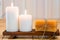 Burning candles and handmade soap on wooden support