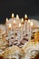 Burning candles on a honey cake. Beautiful white candles burn brightly. Traditional birthday cake. Vertical image