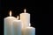 Burning candles isolated on black background.