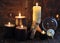 Burning candles and magic crystals on witch wooden table