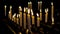 Burning candles standing on candlesticks in the church