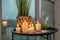 Burning candles on a table with flowers with glasses or fruits, intimate romantic atmosphere