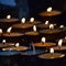 Burning candles in Tibetan Buddhist temple. Himachal Pradesh, India, Buddhist floating colorful Candle floating on water for pray