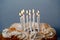 Burning candles on top of a honey cake. Beautiful white candles burn brightly. Traditional birthday cake